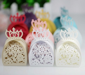 Macro view of laser-cut floral paper candy boxes with elegant crown top closure
