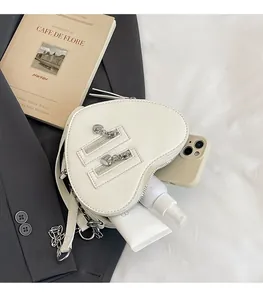 Internal view of white heart crossbody bag showing space for phone and cosmetics