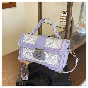 Detail of purple leather trim and geometric jacquard fabric on a vintage square bag