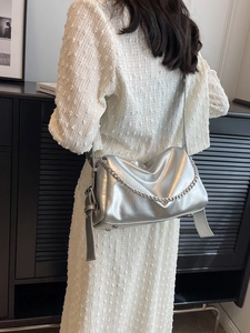 Silver metallic pillow bag with chain strap and wide shoulder belt for women