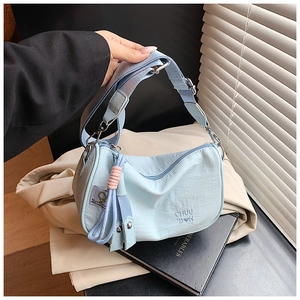 Detail of light blue crescent shoulder bag with branded embossing and woven strap