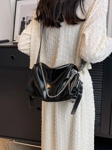 Chic black pleated shoulder bag with chunky metal chain and grommet wide strap details