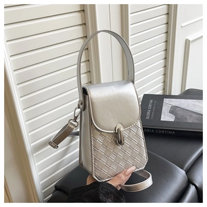 Macro detail of silver woven texture and metallic clasp on a stylish small square bag