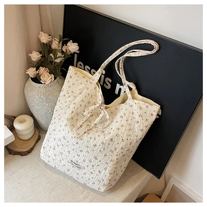 Detail of floral tote bag showing seersucker texture and bow decoration