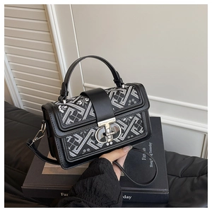 Detailed shot of ethnic jacquard pattern and metal clasp on small square bag