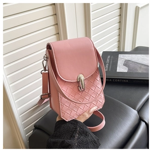 Close-up of pink leather phone bag with woven texture and silver metal clasp