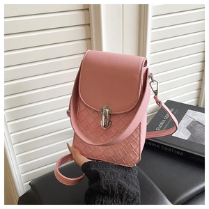 Detail of light pink mini crossbody bag with quilted texture and silver twist lock