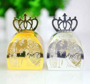 Laser-cut crown wedding favor boxes featuring gold and silver hollow Mr & Mrs designs