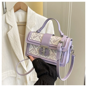 Detail of vintage jacquard square bag with lilac leather trim and metallic twist lock