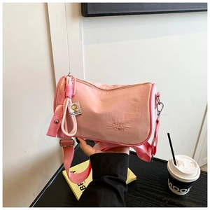 Detail of light pink nylon Boston bag featuring CHUU DON embroidery and adjustable strap