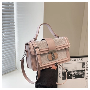 Detail of pink leather and beige jacquard crossbody bag with metal twist lock clasp