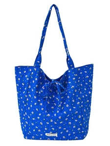 Quilted blue floral canvas tote bag with bow tie closure and Magic Pocket label