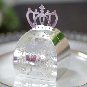 Detailed macro view of laser-cut silver Mr & Mrs wedding favors box with hollow rose pattern