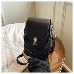 Detailed view of black woven texture leather handbag with silver metallic buckle lock