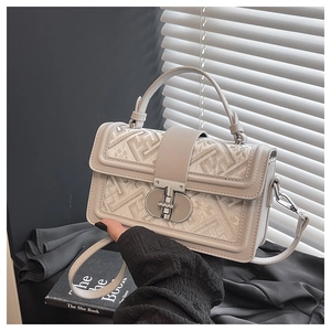 Detail of small square crossbody bag with ethnic jacquard fabric and silver metal clasp