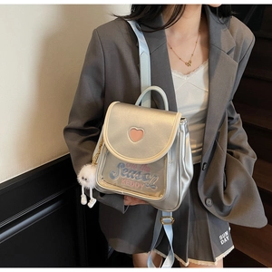 Detail of silver metallic mini backpack with clear pocket and heart-shaped cutout design