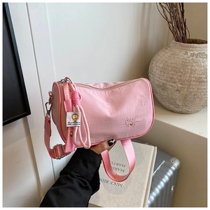 Detail of pink nylon Boston bag with brand embroidery and adjustable wide strap
