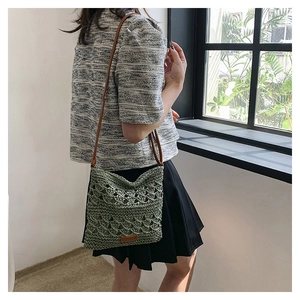 Detail of hand-woven crochet shoulder bag in grass green with boho hollow pattern
