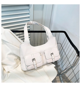 Detail of white leather shoulder bag with silver buckle pockets in a metal basket