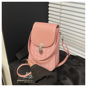 Detail of light pink crossbody bag featuring woven PU leather texture and silver buckle