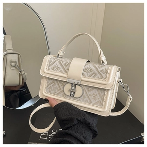 Detailed close-up of a square floral jacquard handbag with silver twist lock and side buckle
