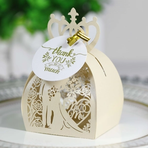 Macro detail of laser-cut wedding favors box with Mr and Mrs silhouette and gold tie