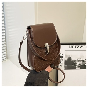 Close-up of small dark brown crossbody bag with woven texture and silver metal lock