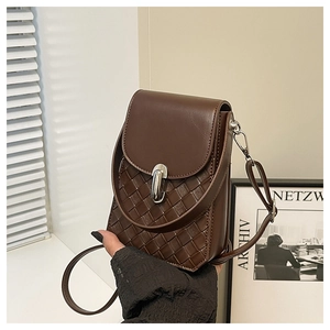Close-up of deep brown leather crossbody bag with woven texture and silver buckle
