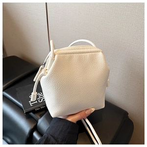 Détail du mini sac seau blanc en cuir grainé avec design géométrique et bandoulière fine