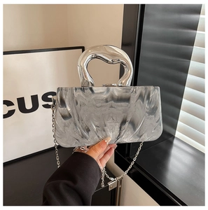 Macro shot of grey marble texture clutch with silver metallic handle and chain strap