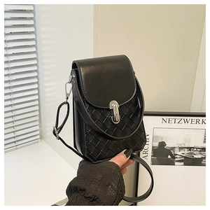 Close-up of woven leather texture and silver metal twist lock on a black crossbody bag