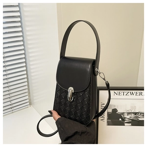 Detail of black woven leather handbag featuring unique silver metal clasp and top handle
