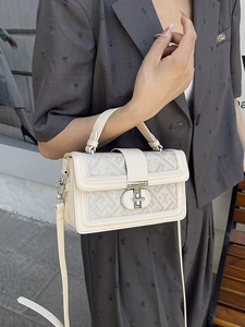 Chic beige crossbody bag with floral jacquard panel and sleek metallic rotary lock
