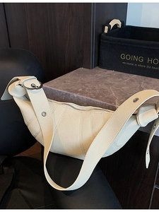 Cream colored lychee pattern leather crescent moon bag with wide shoulder strap