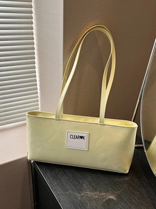 Minimalist light yellow glossy shoulder bag with brand logo and sleek rectangular design