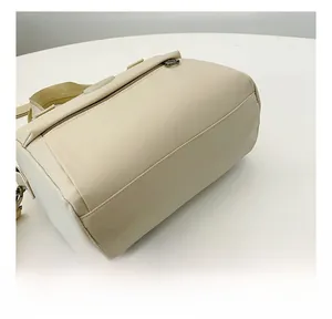 Close-up of cream square bag showing precise stitching and premium nylon texture