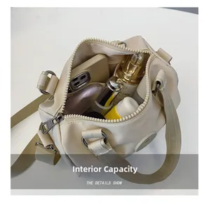 Top view of beige crossbody bag interior showing large capacity for phone and cosmetics