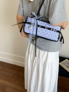 Chic light blue shoulder bag with heart patterns and decorative ribbon bow accent