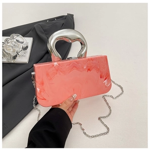 Close-up of pink marble acrylic handbag with silver curved handle and chain strap