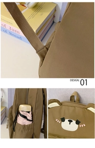 Detail showing side pocket for umbrella and bear embroidery on brown canvas backpack