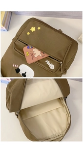 Detail of cute brown canvas backpack showing spacious padded compartment and embroidery