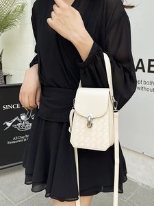 Chic beige woven mini square bag with silver clasp and slim crossbody strap on model