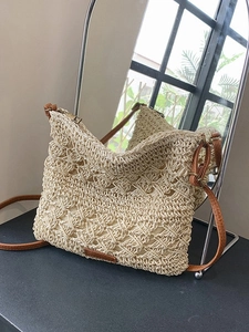 Elegant beige woven straw shoulder bag with leather strap and zipper closure