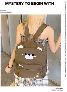Detailed view of cute bear canvas backpack with embroidered fish and star patterns
