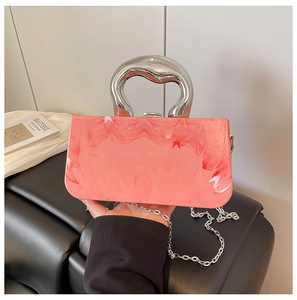 Detail of pink marble pattern handbag with sculptural silver metal handle and chain strap