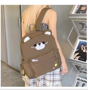 Detail of cute brown bear canvas backpack with cartoon face and stylish adjustable straps