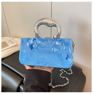 Detailed view of blue and white marble acrylic handbag with unique silver metal handle