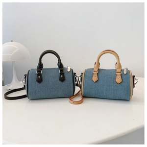 Detail of denim texture boston bags with contrast handles and removable straps