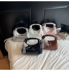 Close-up of luxury handbags with lace bows, pearl charms and fashion embossing