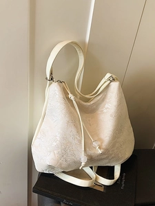 Chic off-white floral jacquard shoulder bag with drawstring and clear beads